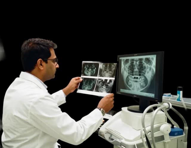 Dentist typing on laptop